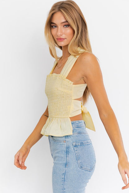 SLEEVELESS SMOCKED PEPLUM TOP